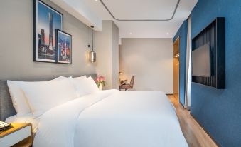 The contemporary bedroom features a white bed and a large window that overlooks the rest area at Country Inn & Suites by Radisson, Guangzhou Yonghe Branch
