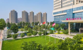 The view from the office building window overlooks a panorama of tall buildings and skyscrapers at Ramada by Wyndham Heze