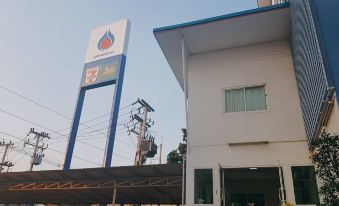 a gas station with a large sign on the side of a building , indicating that it is an oil and gas business at Tulip Place
