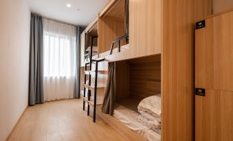 The bedroom features bunk beds and large windows, with an adjacent bathroom that includes a bathtub and separate shower at Dayin International Youth Hostel（East Nanjing Road & The Bund）