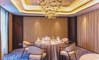 The dining area is decorated with large windows and round tables set for four at Radisson Collection Hotel, Yangtze Shanghai