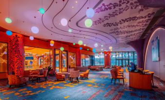 The hotel lobby features a spacious area in the front with additional furniture on both sides at Chimelong Spaceship Hotel