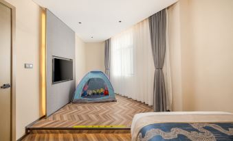 a modern bedroom with a large window , wooden flooring , and a bed with blue bedding , as well as a tent - like structure in the at Mehood  Lestie Hotel