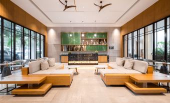 A spacious room with contemporary furniture and an open layout connecting to the living area, featuring a couch at Vienna International Hotel (Baoting Center)