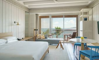 a bedroom with a large bed , couch , and sliding glass doors leading to an outdoor patio at Park Hyatt St Kitts Christophe Harbour