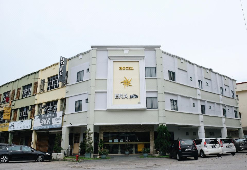 "a large hotel building with a sign that reads "" hotel "" prominently displayed on the front of the building" at Era Plus Hotel