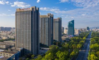 The cityscape features tall buildings and skyscrapers in the foreground when viewed from a high vantage point at Maision New Century Hotel Keqiao Shaoxing