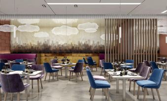 restaurant with ample natural light and centrally located tables, accompanied by an adjacent open space at Novotel Guangzhou Baiyun Airport (Terminal)