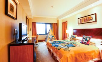 The orange-themed room features a spacious bed, a desk, and two windows offering views of the outside at Radisson Collection Hotel, Yangtze Shanghai