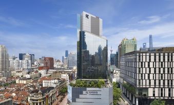 The aerial view showcases urban buildings and skyscrapers at Radisson Collection Hyland Shanghai