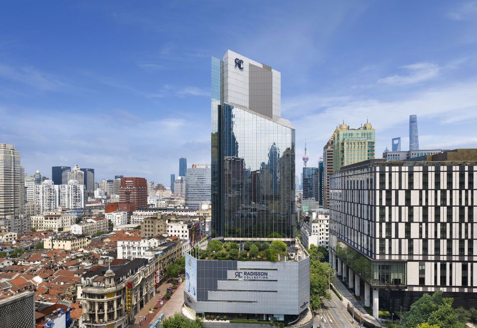 The aerial view showcases urban buildings and skyscrapers at Radisson Collection Hyland Shanghai