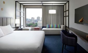 a hotel room with two beds , one on the left and one on the right side of the room at Doubletree by Hilton Montreal