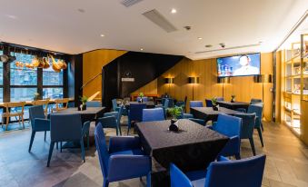 The restaurant features blue chairs and tables in the center, creating an open concept dining area at CitiGO Hotel Jing'an Shanghai