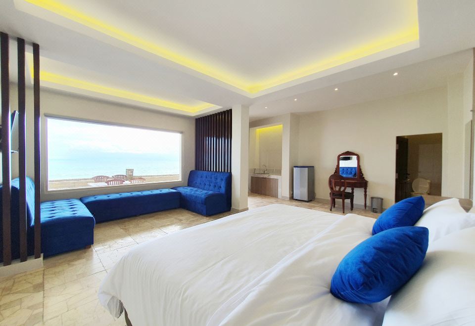 a luxurious hotel room with a large bed , white linens , and a view of the ocean at 77 Sunset Plaza