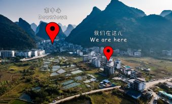 The city is depicted with mountains in the background, and the image has been altered to align with this scenery at Yangshuo Sudder Street Guesthouse