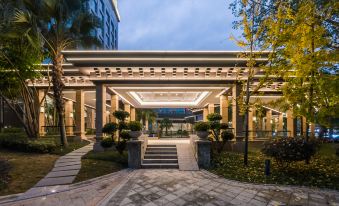 The hotel entrance features an outdoor view and a stone walkway that leads to another area at Fuzhou Oriental Yanzhuo Hotel