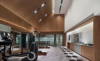 The gym is designed to resemble a spacious room with a floor, ceiling, and windows at UrCove by HYATT Nanjing South Railway Station