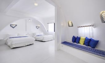 a white bedroom with two beds , one on the left and one on the right at Vitalis Villas