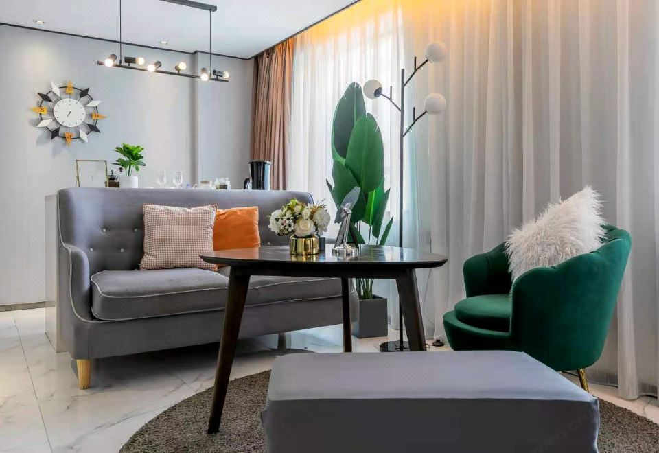 The living room is open and includes a sofa, coffee table, and other furniture in the background at Guangzhou Feiyang Apartment