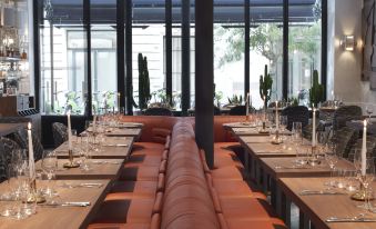 a long dining table with multiple chairs arranged around it , creating a long and inviting atmosphere at Hotel Bachaumont