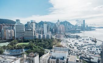 from the highest level of the hotel, capturing the surrounding urban landscape of buildings and skyscrapers at Empire Hotel Hong Kong - Causeway Bay