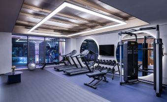 A spacious room with multiple exercise equipment and a central indoor fitness center is also available at Crystal Orange Shenzhen Nanshan Science and Technology Park