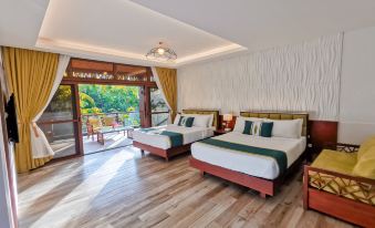 a hotel room with two beds , one on the left and one on the right side of the room at Loboc River Resort