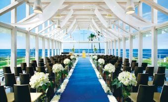 a wedding ceremony taking place on a yacht , with rows of chairs arranged for guests at Malibu Hotel