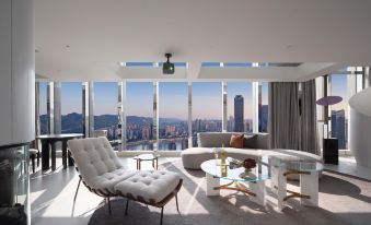 The apartment features a spacious living room with large windows and floor-to-ceiling glass, providing a panoramic view of the city at ISEYA HOTEL （Chongqing Jiefangbei Raffles Plaza)