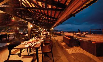 an outdoor dining area at a restaurant , with tables and chairs arranged for guests to enjoy a meal at Resorts World Kijal