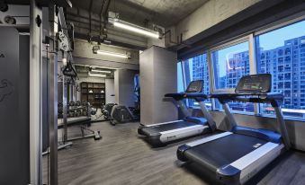 adjacent gymnasium featuring treadmills and expansive windows at Wanda Moments