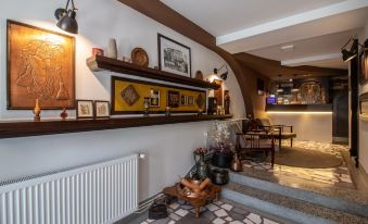 a cozy living room with a wooden staircase leading to the second floor , filled with various furniture and decorations at Villa Varosh