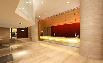 The ground floor features a spacious lobby adorned with wood paneling and marble countertops at Prudential Hotel