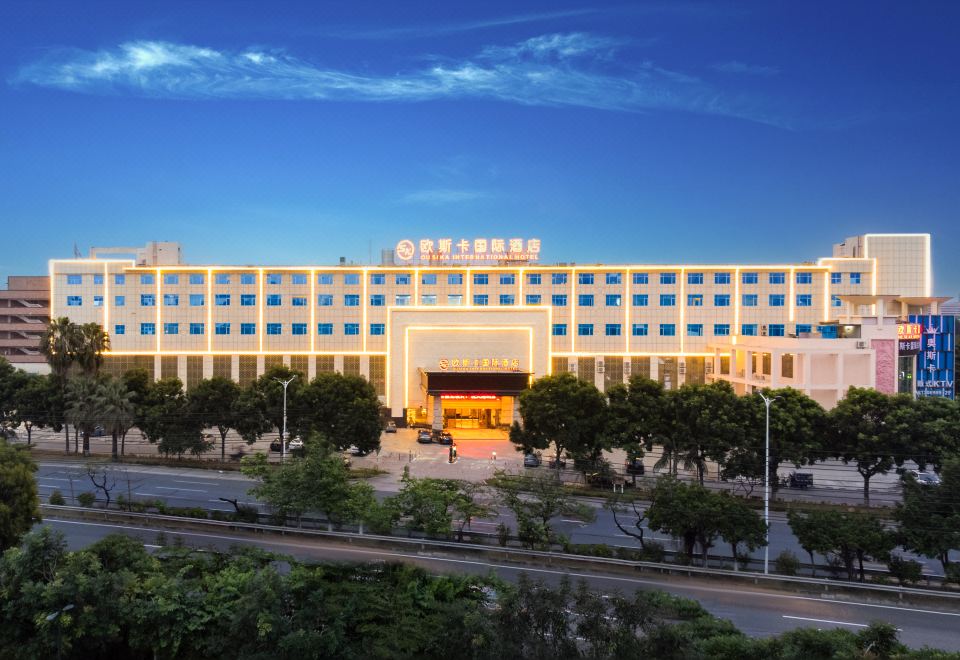 "There is a large building with the word ""hotel"" on the front and another building behind it" at Ousika International Hotel (Dongguan Gaobu Tongfu)