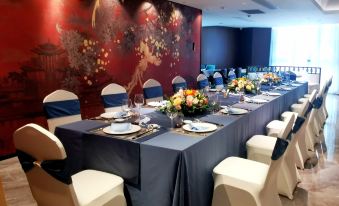 A room is arranged for an event with long tables and matching chairs placed in the center at Fuzhou Oriental Yanzhuo Hotel