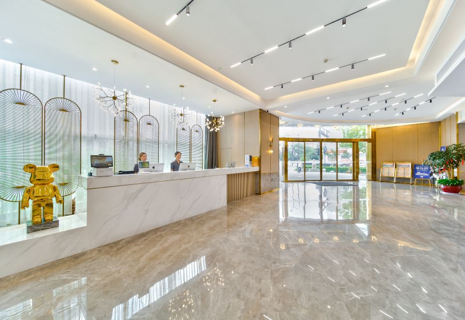 The lobby of this residential-style building is clean and modern, featuring a large marble countertop at Oukai Hotel