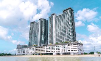 a large building with a unique design , situated on the beach near the water and surrounded by trees at Swiss-Belhotel Kuantan