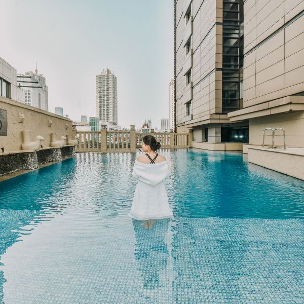 Jakarta hotel pool with city buildings in the background
