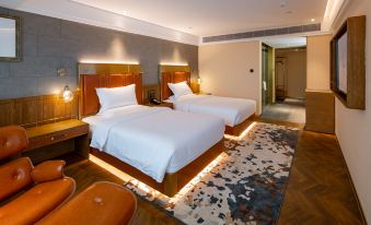 The spacious bedroom features two double beds and an adjoining sitting area for two at Guangzhou Tianhe Taikoohui - Coffee Rupin Hotel