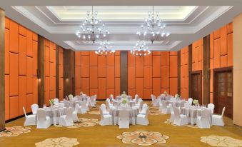 a large , elegant dining room with multiple tables and chairs arranged for a formal event at Sheraton Kosgoda Turtle Beach Resort