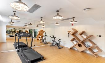 The home features a spacious living area with a large gym for exercising at Holiday Inn Express Xiamen Tongan