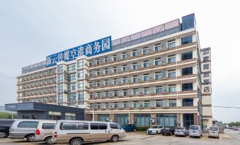 The front view of an apartment complex in Hong Kong, seen from across a parking lot at Homeinn Selected Hotel (Shanghai Pudong International Airport)