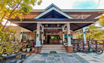 the entrance to a building with a large stone floor and potted plants in front at Loboc River Resort