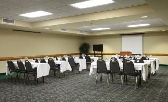 a conference room set up for a meeting , with tables and chairs arranged in rows at The Waters of Minocqua