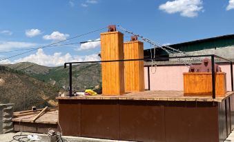 a building under construction with two tall wooden structures , one on the left and one on the right side of the image at Grand House hotel & zipline