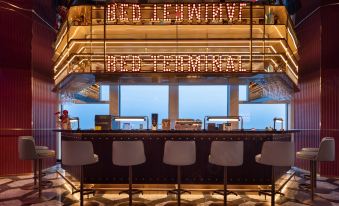 The bar at Person's in Singapore offers ample seating and a large window at Radisson RED Guang Zhou South Railway Station