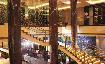The large building features a lobby and staircase with floor-to-ceiling glass partitions on both floors at Jinglun Hotel