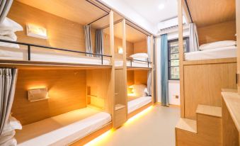 The middle room features bunk beds and large windows, while the adjacent room offers a queen-sized bed and a balcony with city views at Hangzhou Wulin International City Camp (West Lake Wulin Gate Subway Station Store)