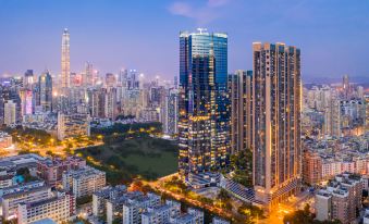 A city at night with tall buildings and skyscrapers in the background at ICON LAB Hotel Shenzhen Futian