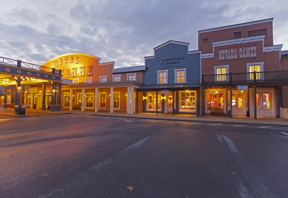 a street view of a town with shops and buildings , taken at dusk or dawn at Disney Hotel Cheyenne